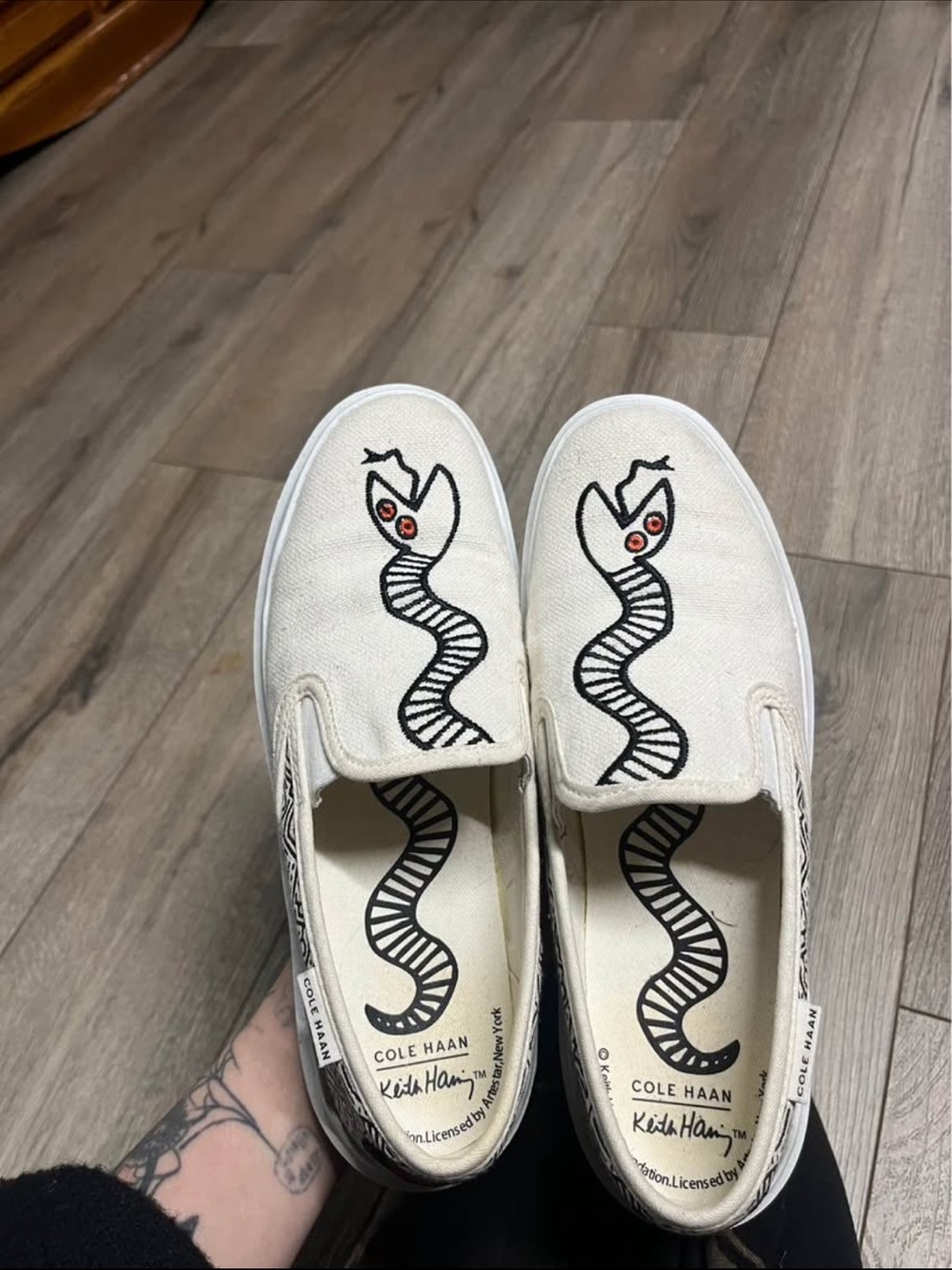 Cole Haan White Canvas Slip-On Sneakers with Black Snake and Red Eye Detail